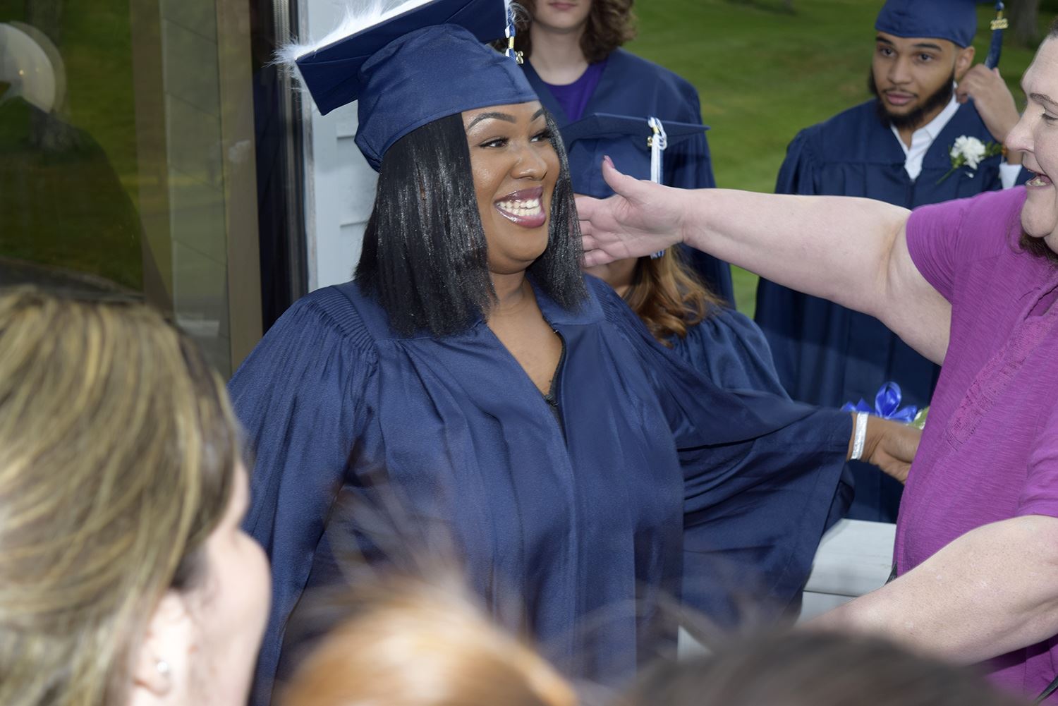 Graduate going to hug one of her teachers